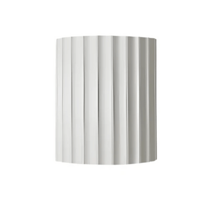 Silver cylindrical object with vertical stripes on a white background