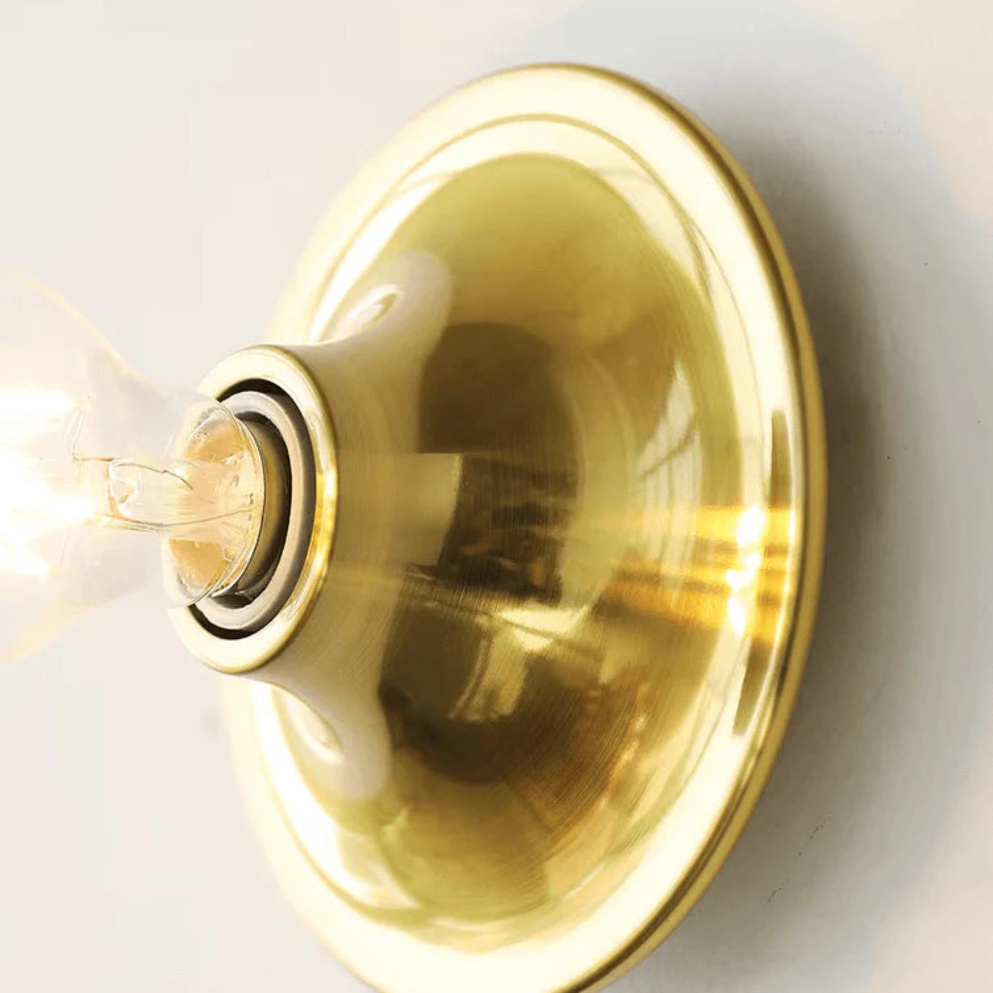 Gold light fixture on a white background
