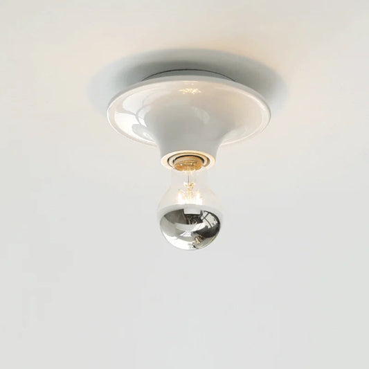 Ceiling light fixture with a glass bulb on a white background