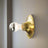 Gold wall light fixture on a white wall with 'Gold' label above.