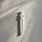 Silver tool handle on a neutral background.