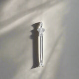 Silver tool handle on a neutral background.