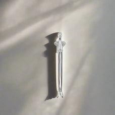 Silver tool handle on a neutral background.