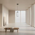 Modern pendant light with cylindrical glass shade on a gray background