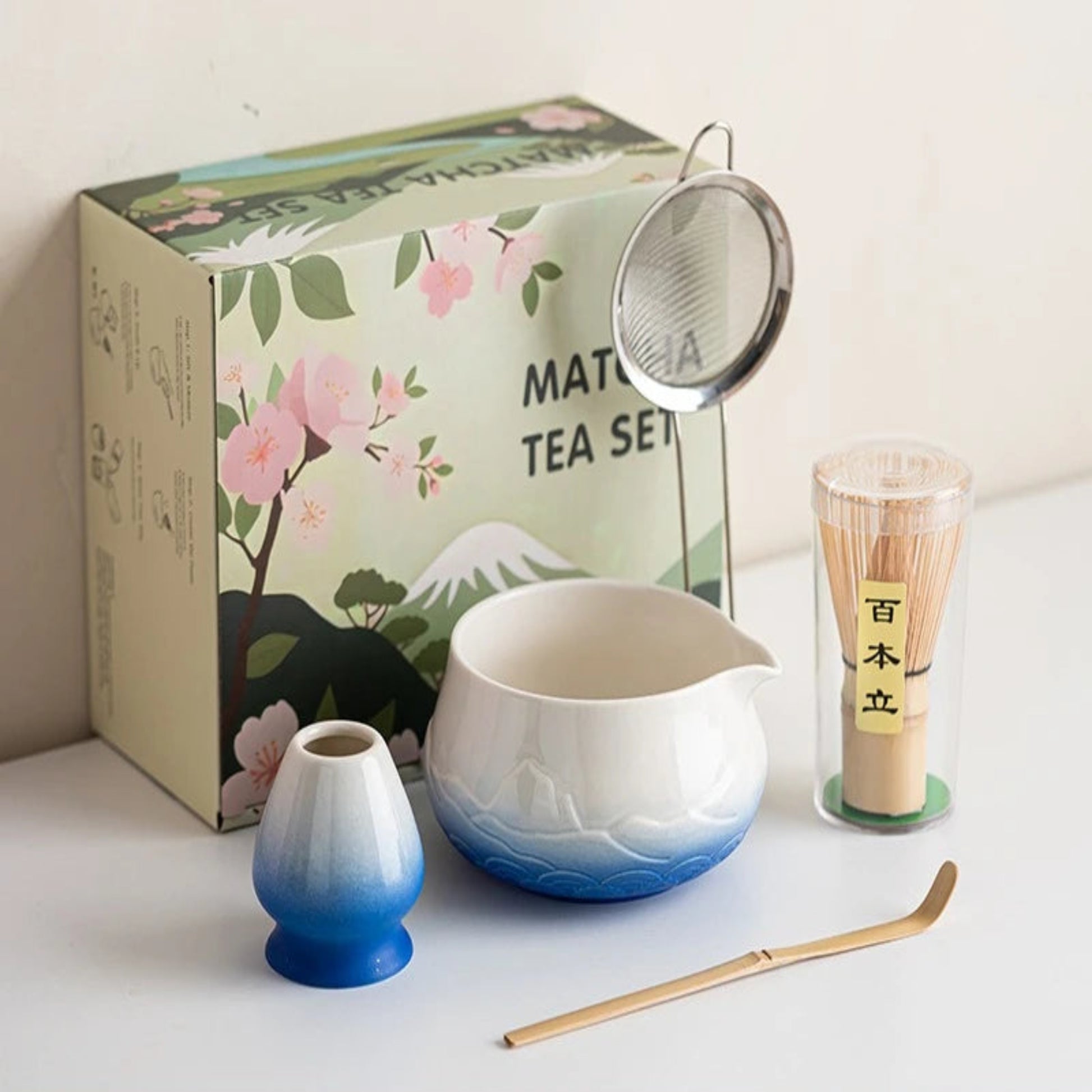 Matcha tea set with a decorative box featuring cherry blossoms and Mount Fuji.