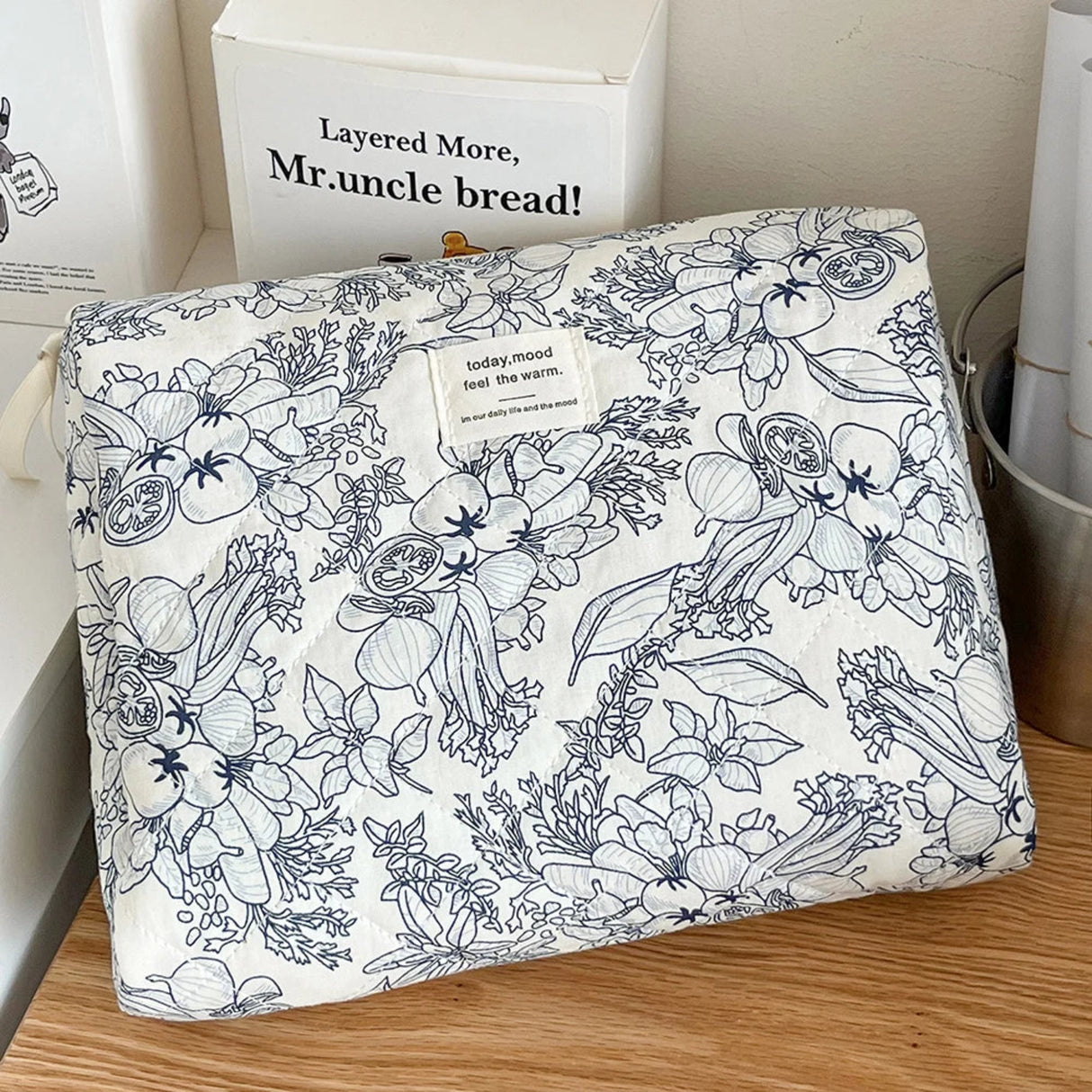 Floral patterned fabric on a wooden surface with a box labeled 'Mr. uncle bread' in the background.