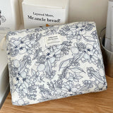 Floral patterned fabric on a wooden surface with a box labeled 'Mr. uncle bread' in the background.