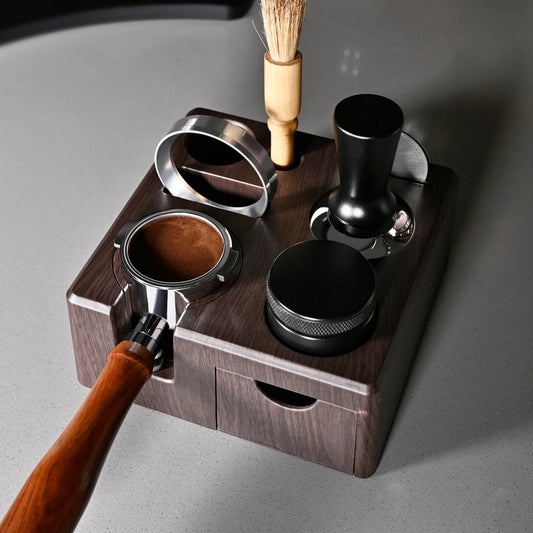 Wooden tea-making set with metal components on a gray surface
