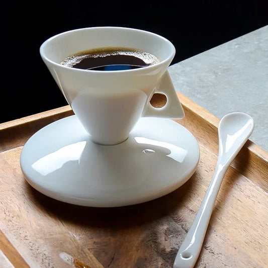 White ceramic coffee dripper with coffee on a wooden tray