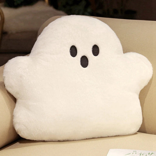 White ghost-shaped cushion on a beige couch