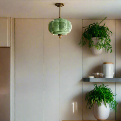 Modern kitchen with a green pendant light.