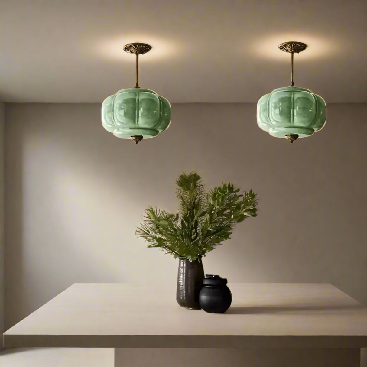Kitchen with green pendant lights, marble backsplash, and wooden table.