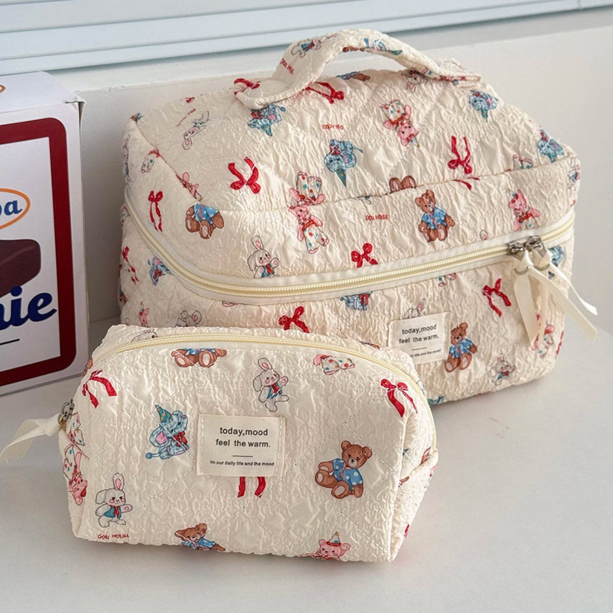 Two patterned bags with teddy bear designs on a white surface.