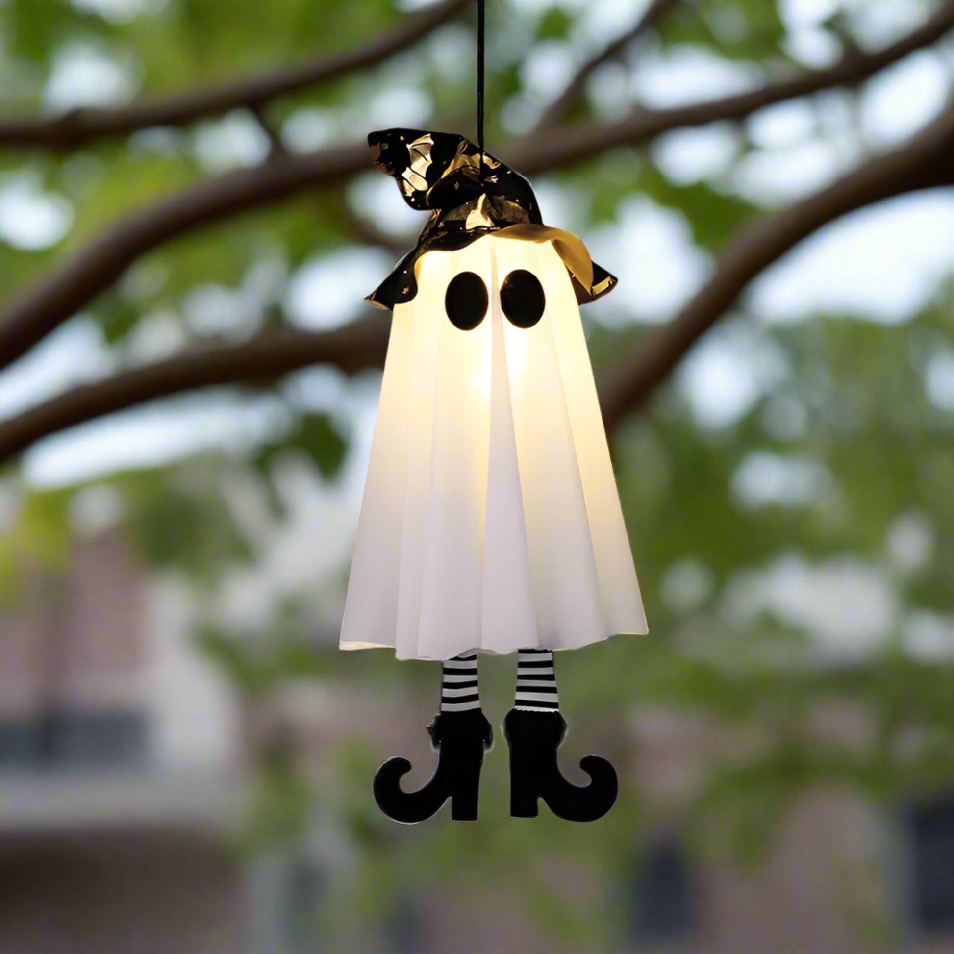 Halloween-themed ghost costume with a black hat, white cape, and striped socks on a white background