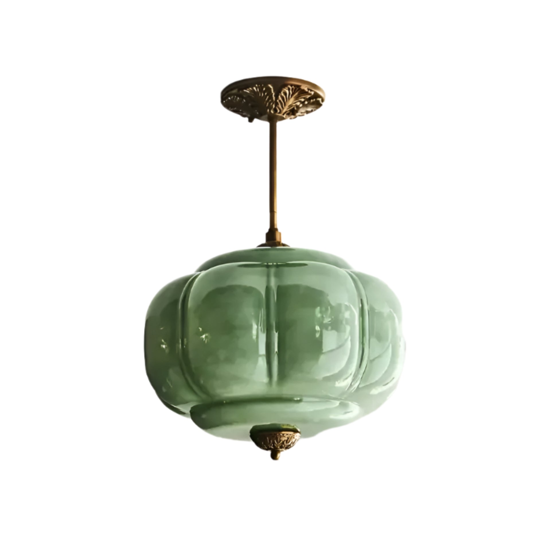 Green glass pendant light fixture on a white ceiling
