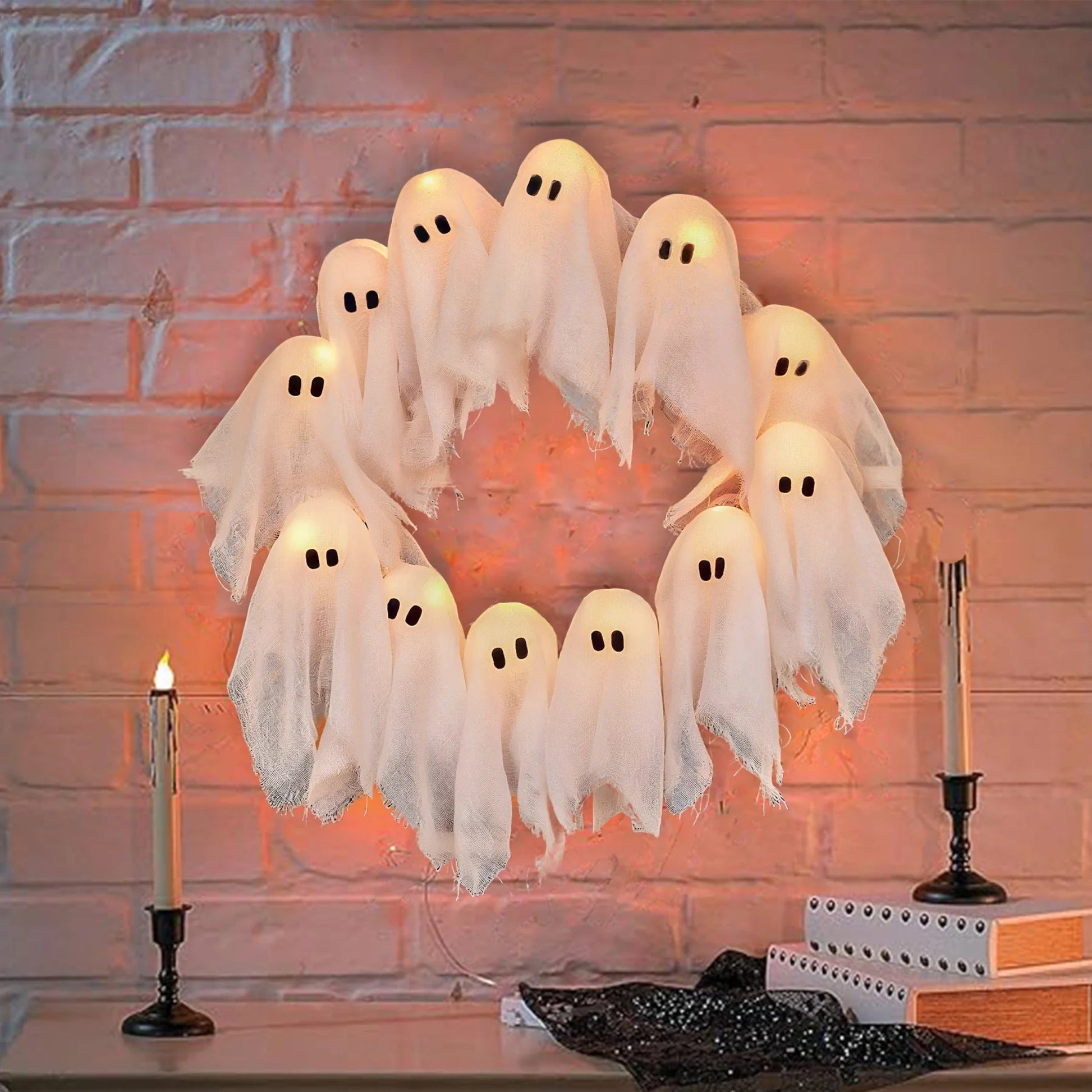 Halloween ghost decorations on a brick wall background