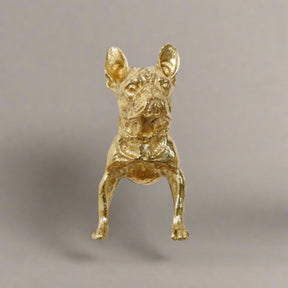 Gold dog figurine on a white background