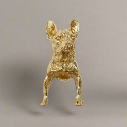 Gold dog figurine on a white background