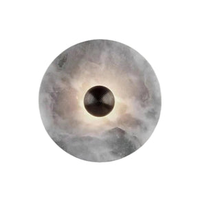 Round wall light fixture with a textured surface on a gray background