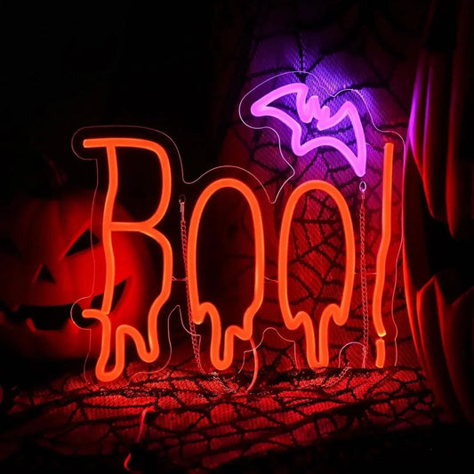 Neon sign with 'BOO!' text on a Halloween-themed background with pumpkins and spider webs.