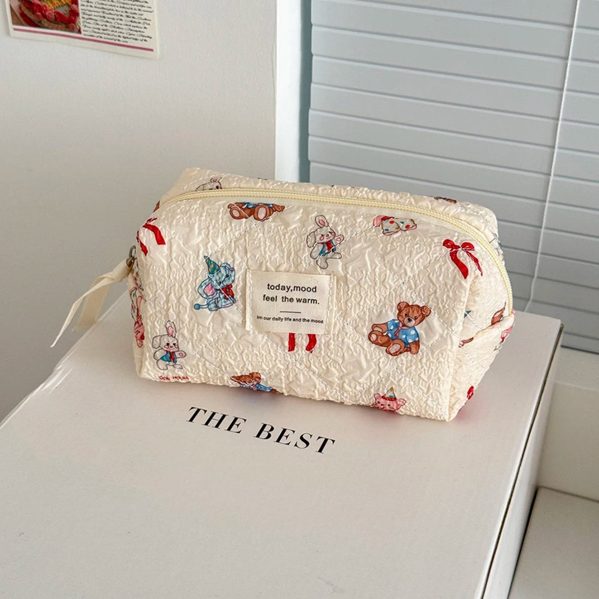 Small pouch with teddy bear pattern on a white surface