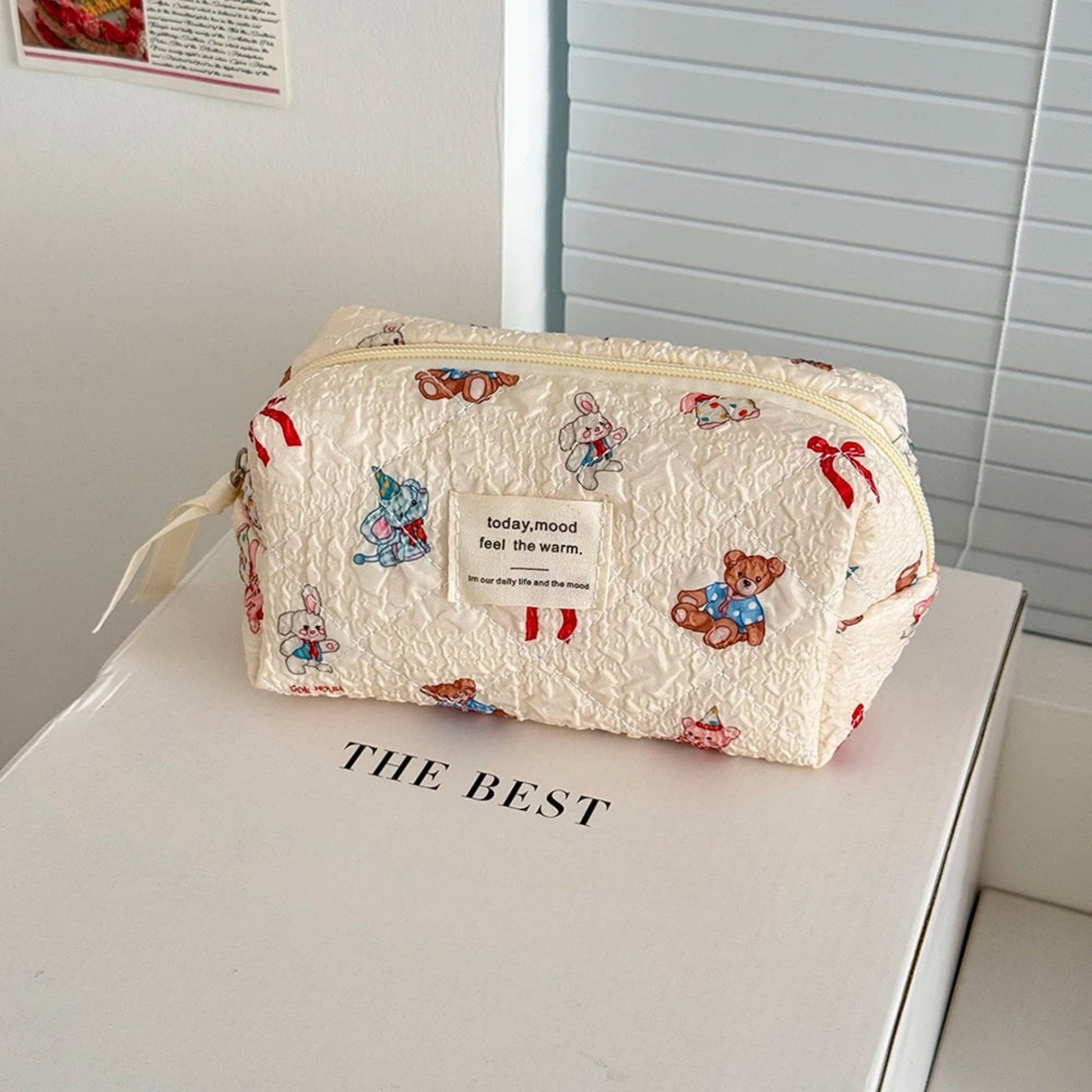 Small pouch with teddy bear pattern on a white surface