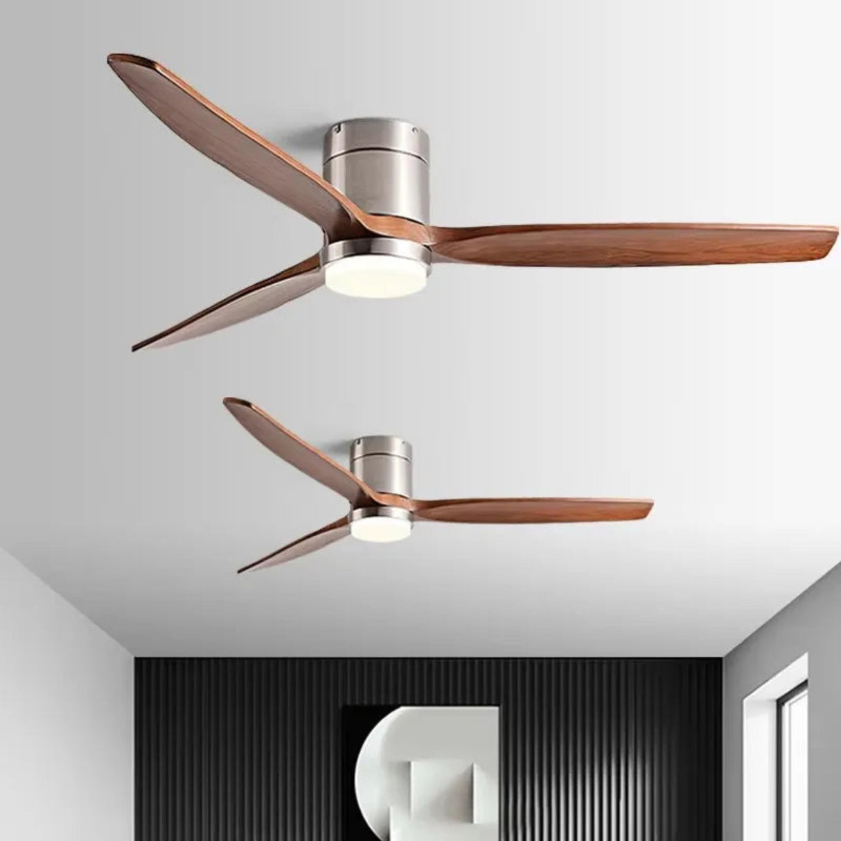 Modern ceiling fans with wooden blades on a white ceiling.