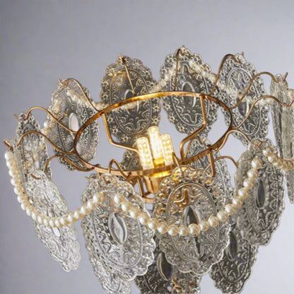 Decorative chandelier with intricate design and pearl-like elements on a dark background