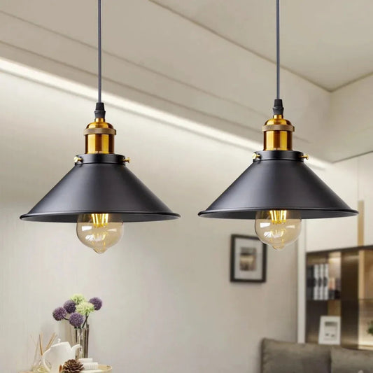 Two black pendant lights hanging in a room with a neutral color scheme.