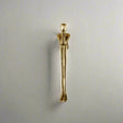 Gold-colored door handle on a neutral background