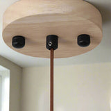 Wooden lamp base with black connectors on a white background