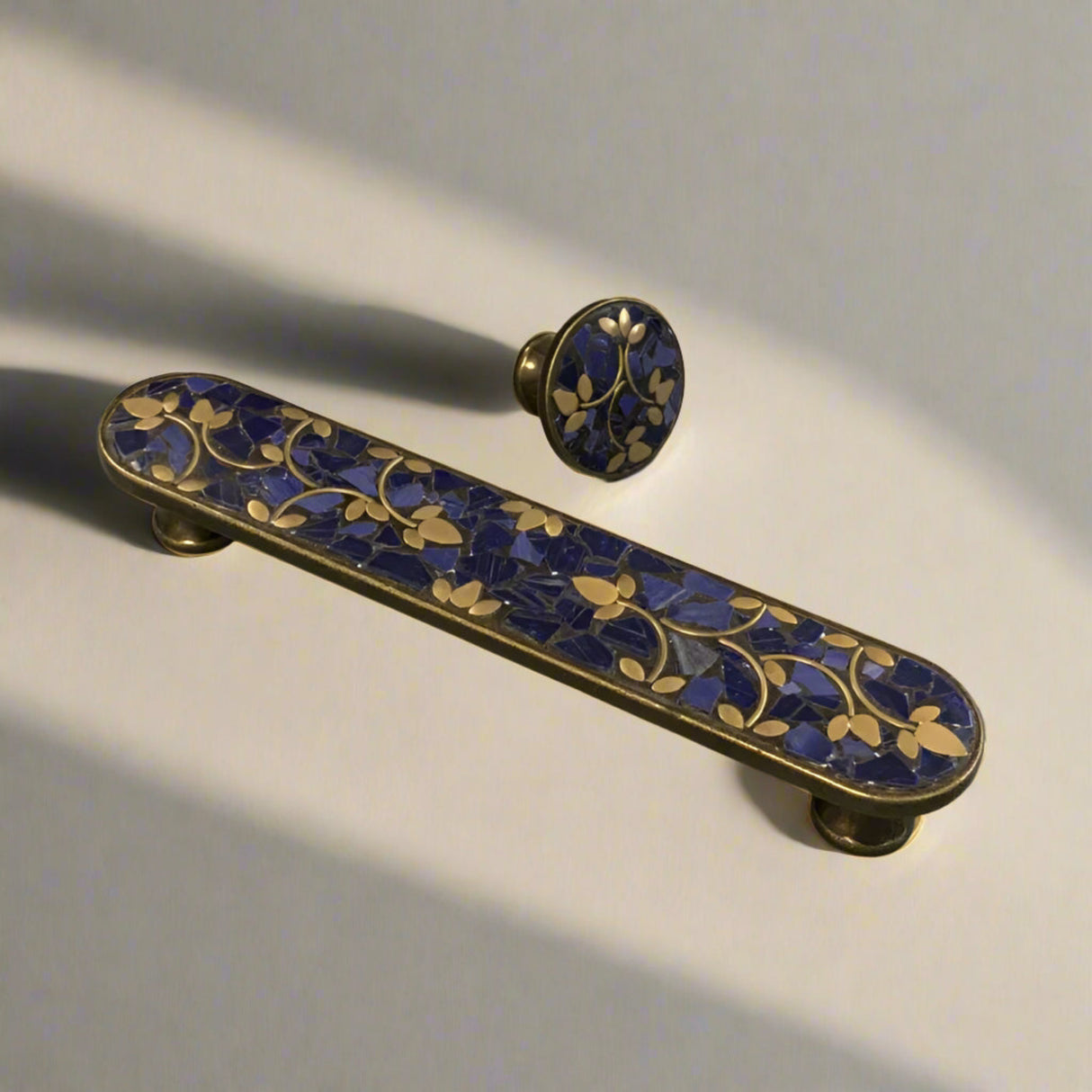 Decorative handle with blue and gold design on a plain background