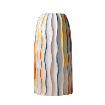 Colorful striped vase on a beige background