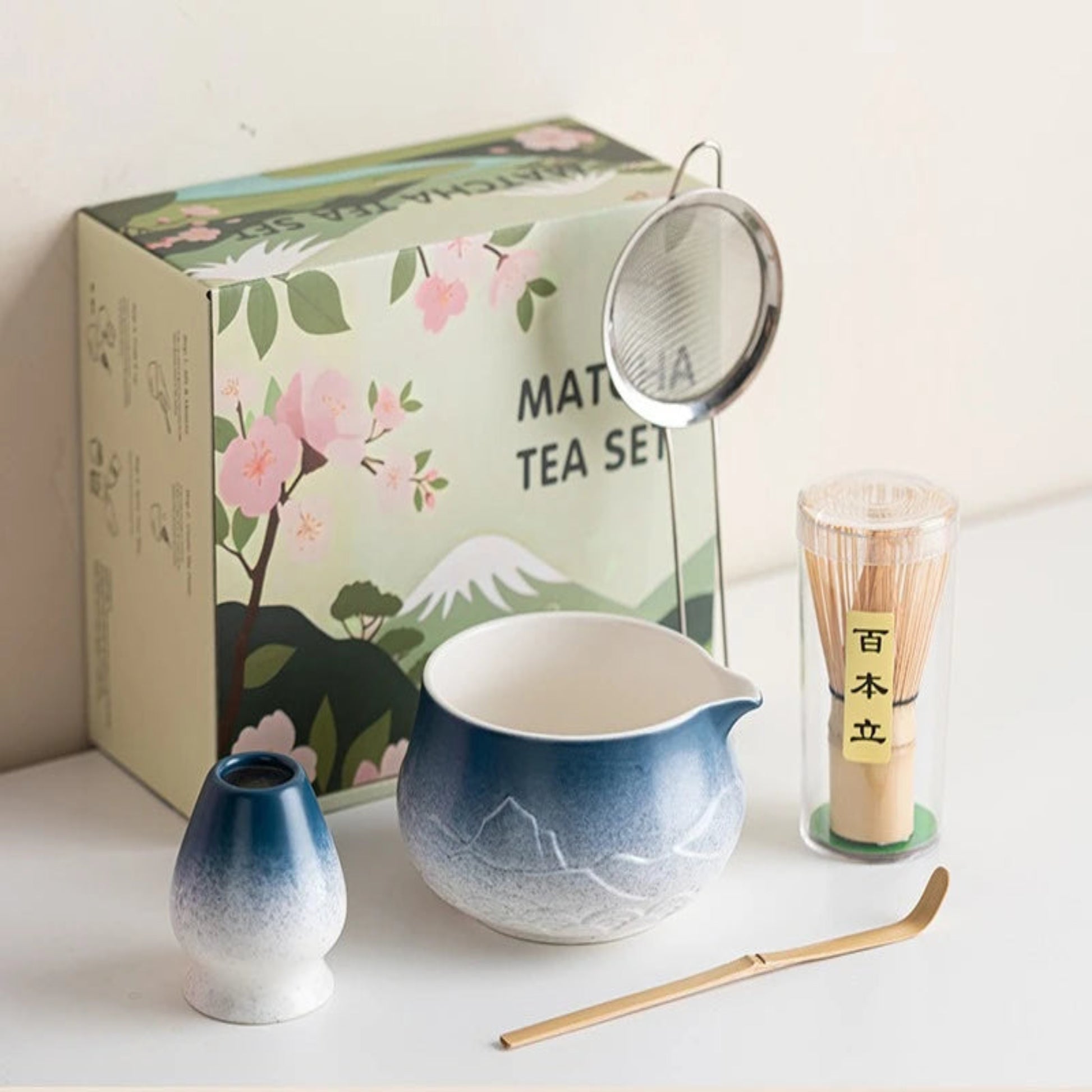 Tea set with a matching tea box on a white surface