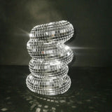 Decorative lamp made of reflective tiles on a dark background