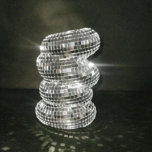 Decorative lamp made of reflective tiles on a dark background