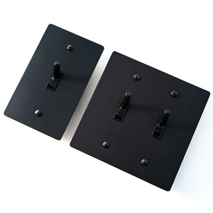 Two black metal brackets on a white background