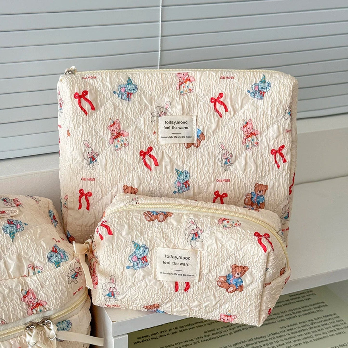 Two patterned bags with teddy bear designs on a white surface.