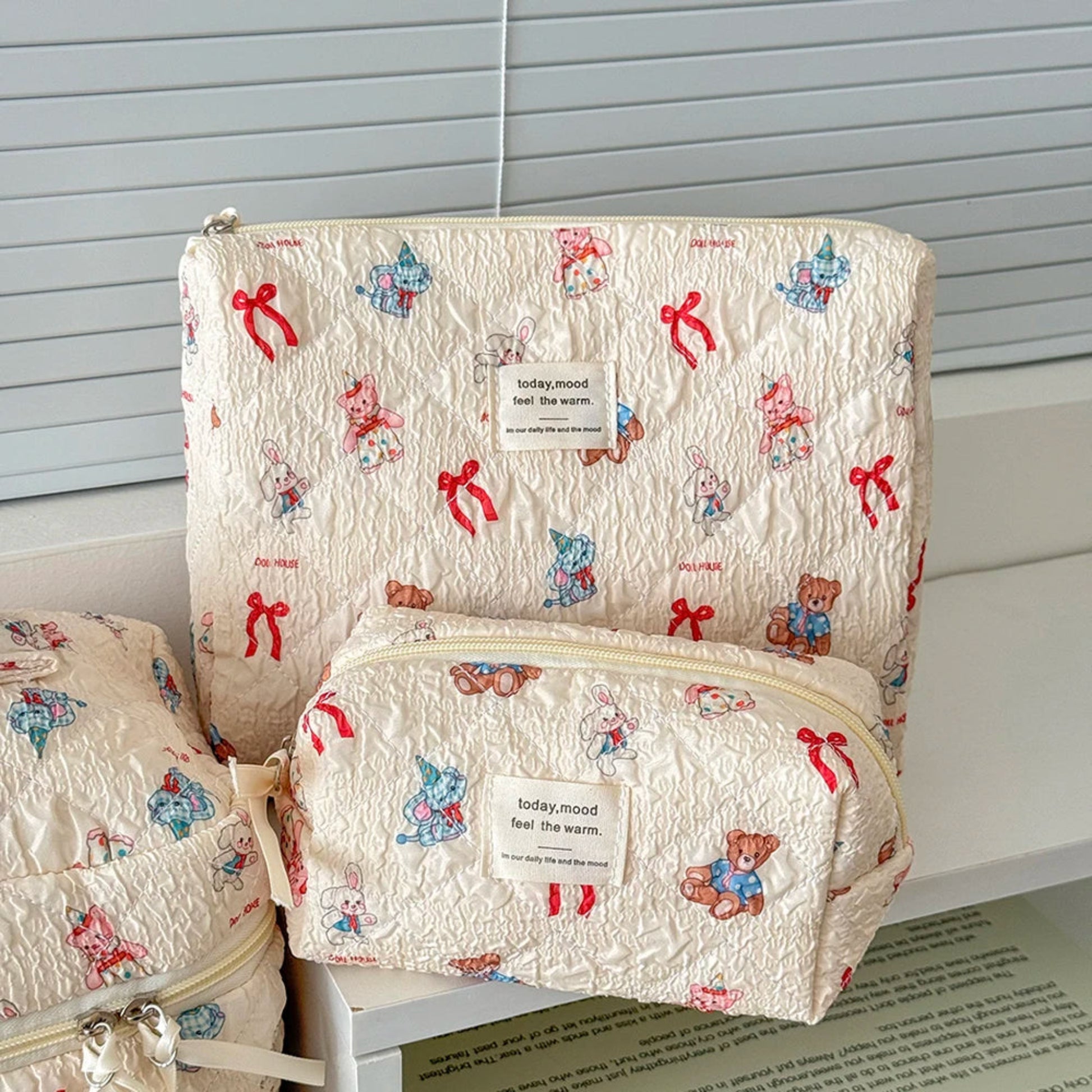 Two patterned bags with teddy bear designs on a white surface.