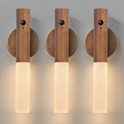 Three wooden wall sconces with light fixtures on a neutral background