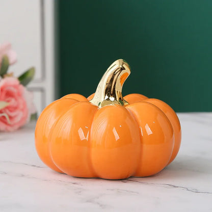 Decorative pumpkin with a gold stem on a marble surface