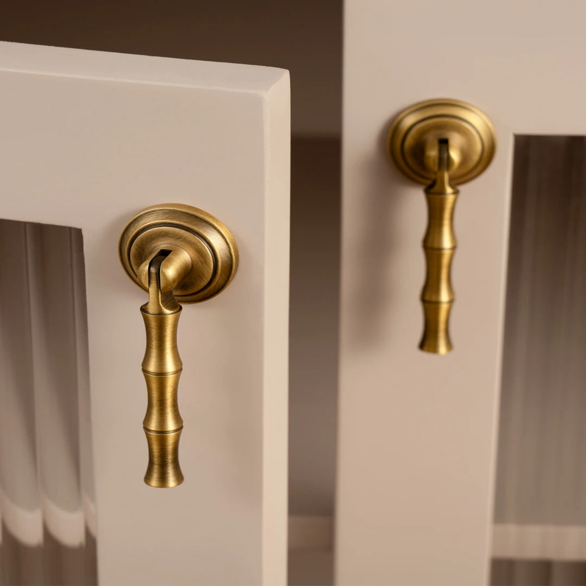 Gold cabinet handles on a neutral background 