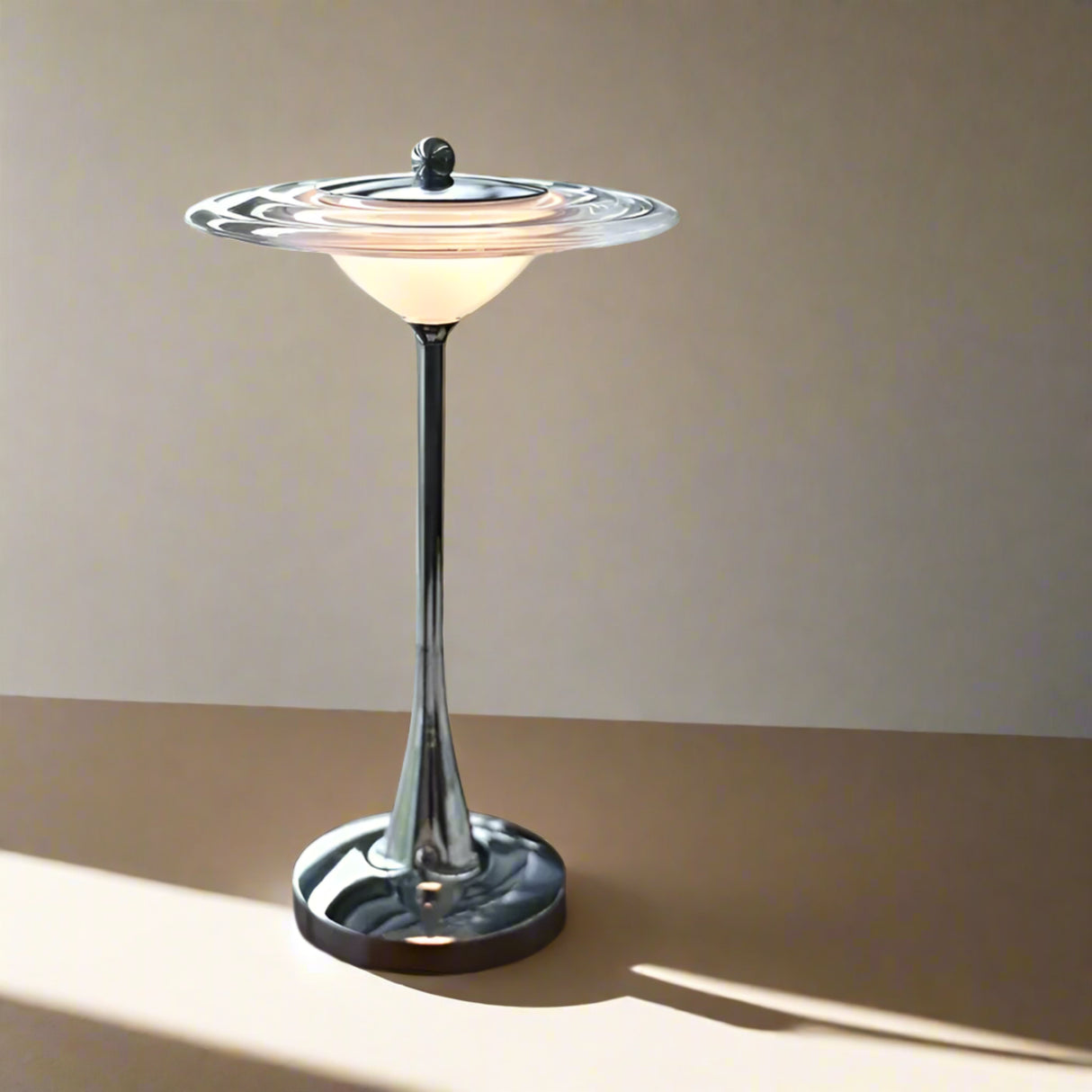 Decorative table lamp on a surface with books and a window in the background