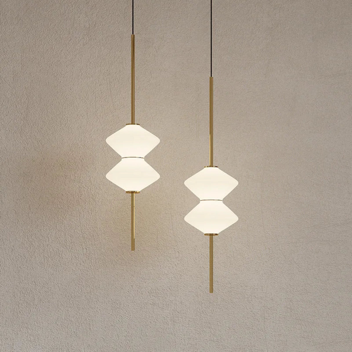 Two geometric pendant lights hanging against a plain wall.
