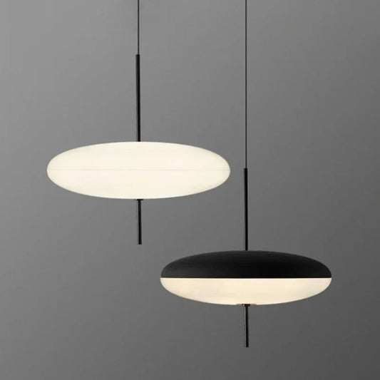 Two pendant lights, one white and one black, on a gray background
