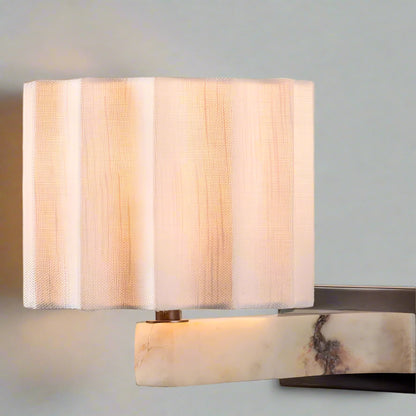 Wall-mounted lamp with marble base and striped shade on a light background, featuring No.7 Lighting logo.