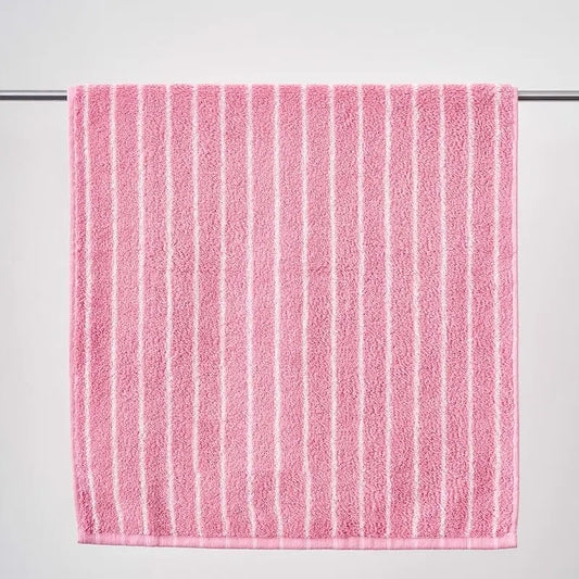 Pink towel with white stripes on a gray background