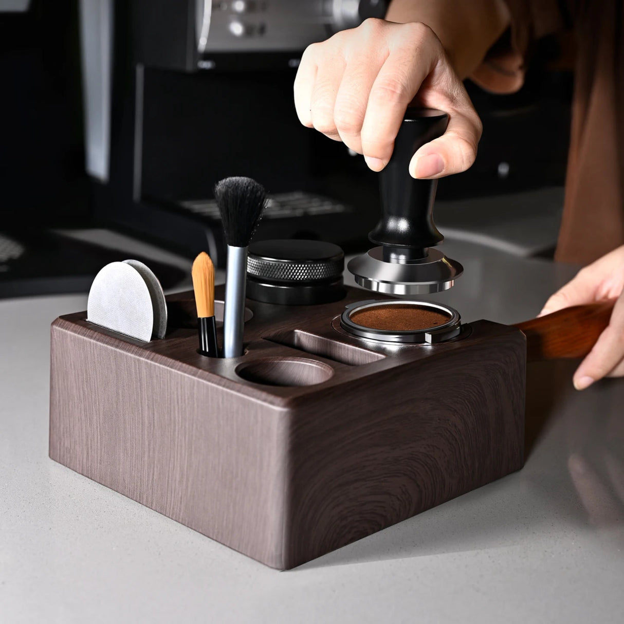 Wooden brush holder with makeup tools on a gray surface