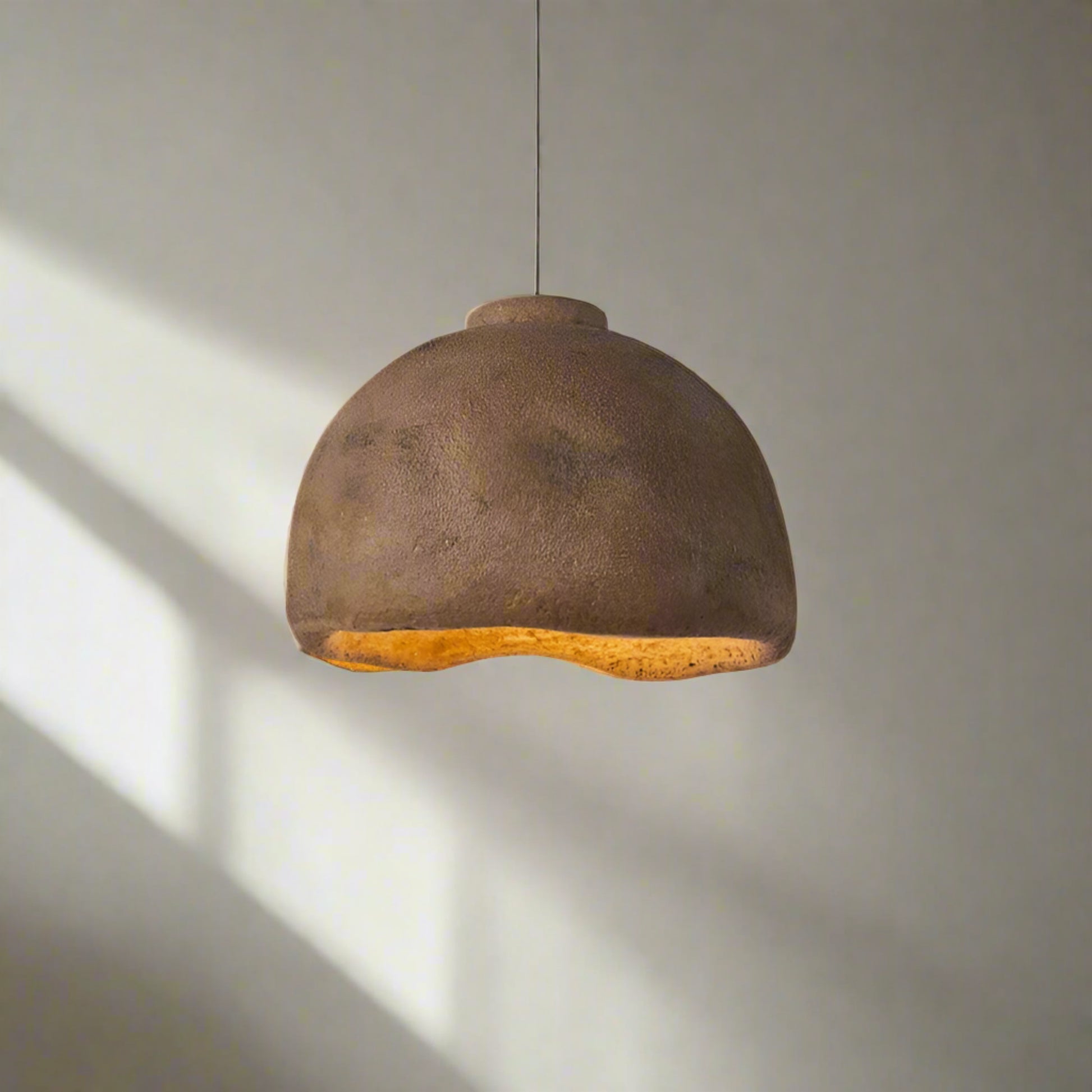 Brown pendant light with measurements on a neutral background