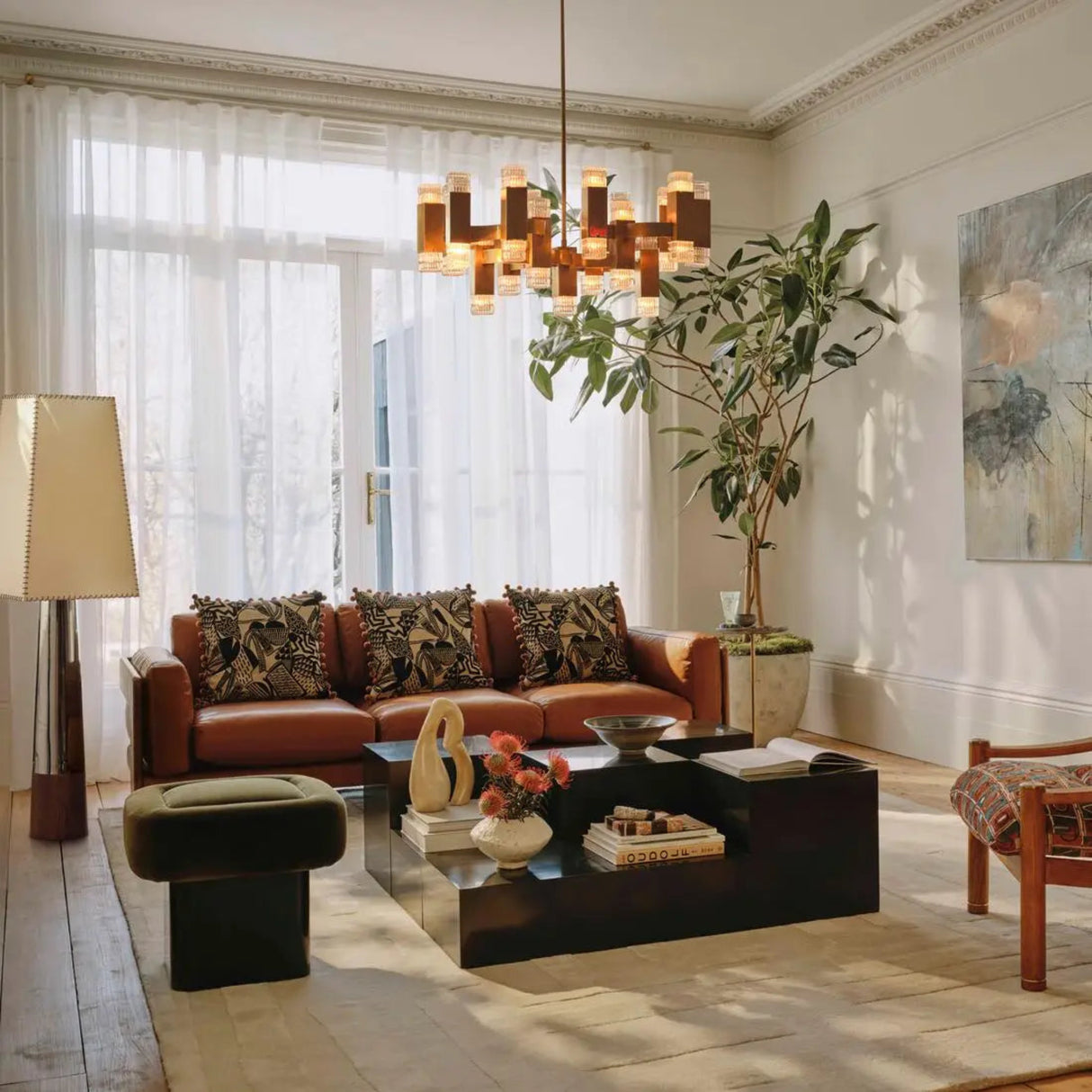 Modern living room with brown leather sofa, coffee table, and decorative items.